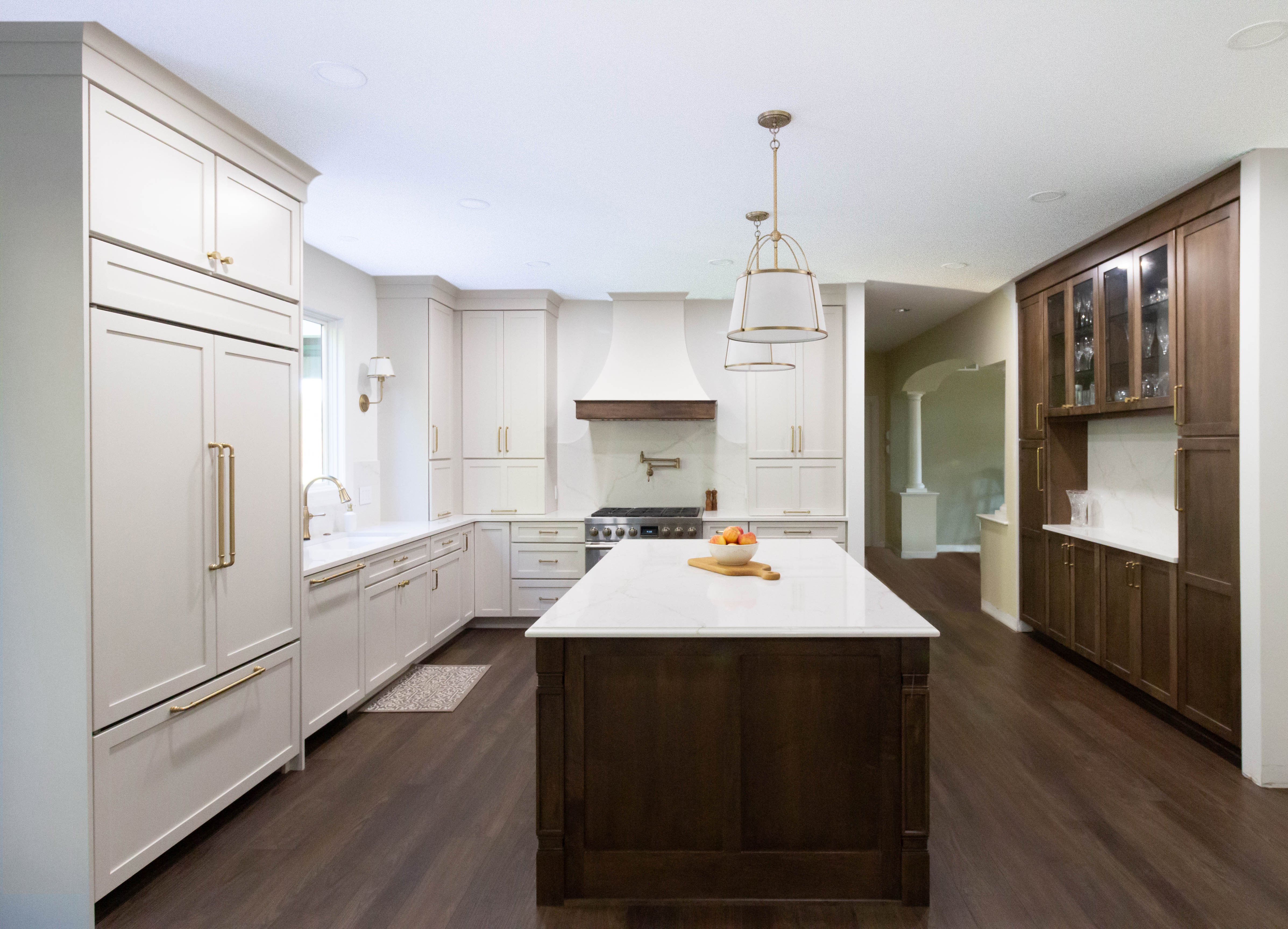 Two-toned kitchen featuring painted cabinetry and wood stain