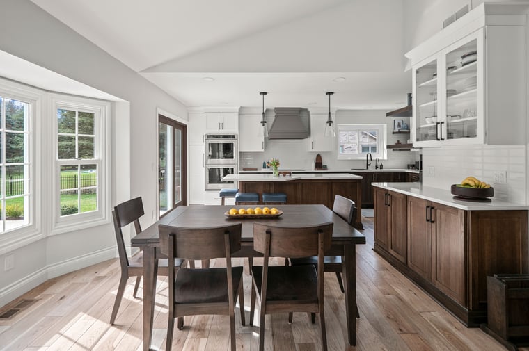 Kitchen featuring Medallion Cabinetry in Hickory with French Roast Stain on lower cabinets, Sea Salt paint on upper cabiners, and Frappe paint on the hood. Designed by KSI Sr. Designer Krista Daily.