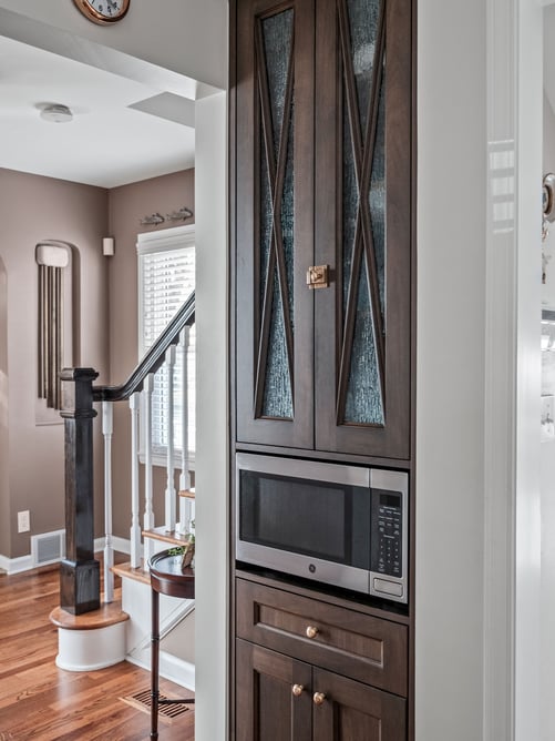 Walnut cabinetry with decorative glass