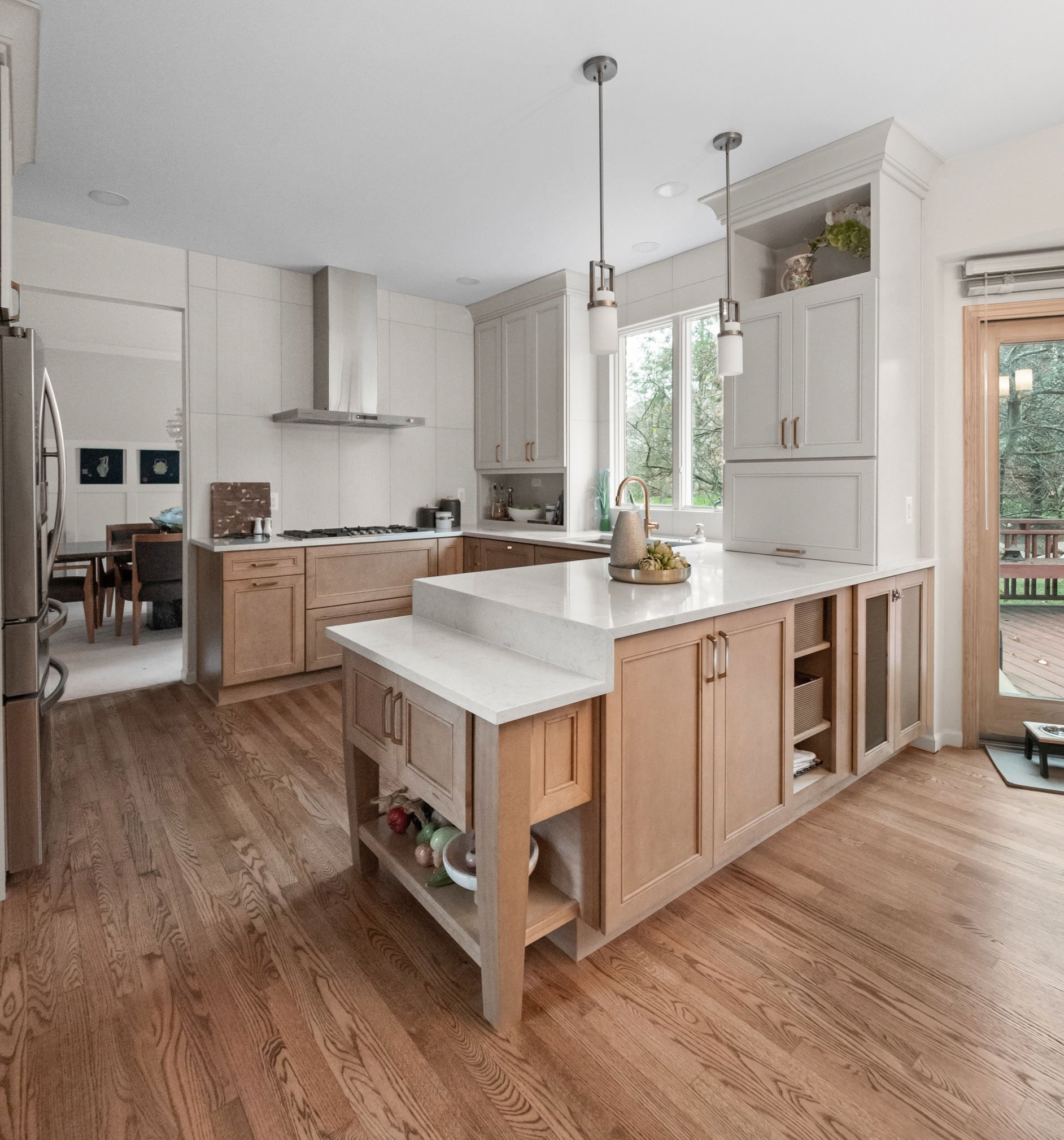 Kitchen featuring Masterpiece Cabinetry in the Coleson door style with maple in Wicker stain and Cottage paint