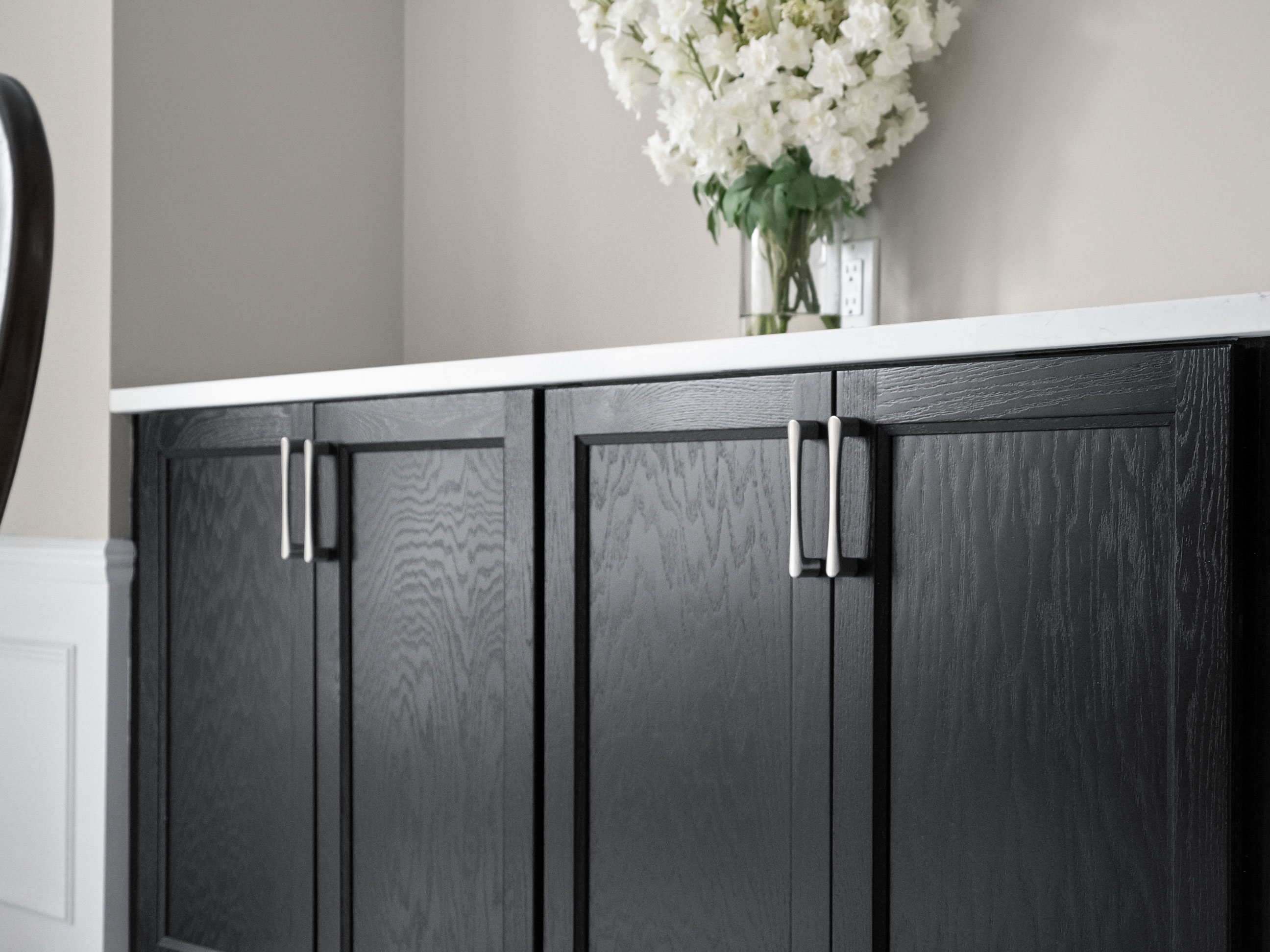 Medallion Cabinetry Wallace door style in Oak with Carriage Black paint