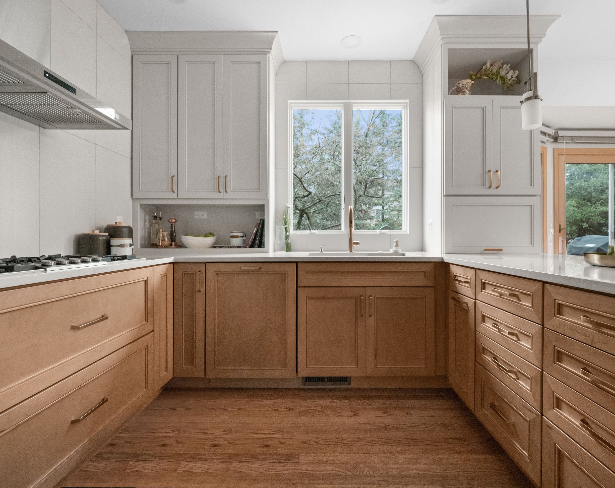 Kitchen featuring Masterpiece Cabinetry in the Coleson door style with maple in Wicker stain and Cottage paint