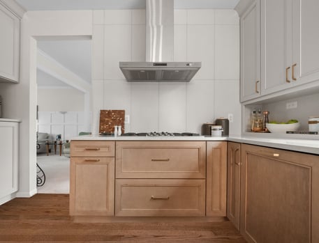 Kitchen featuring Masterpiece Cabinetry in the Coleson door style with maple in Wicker stain and Cottage paint