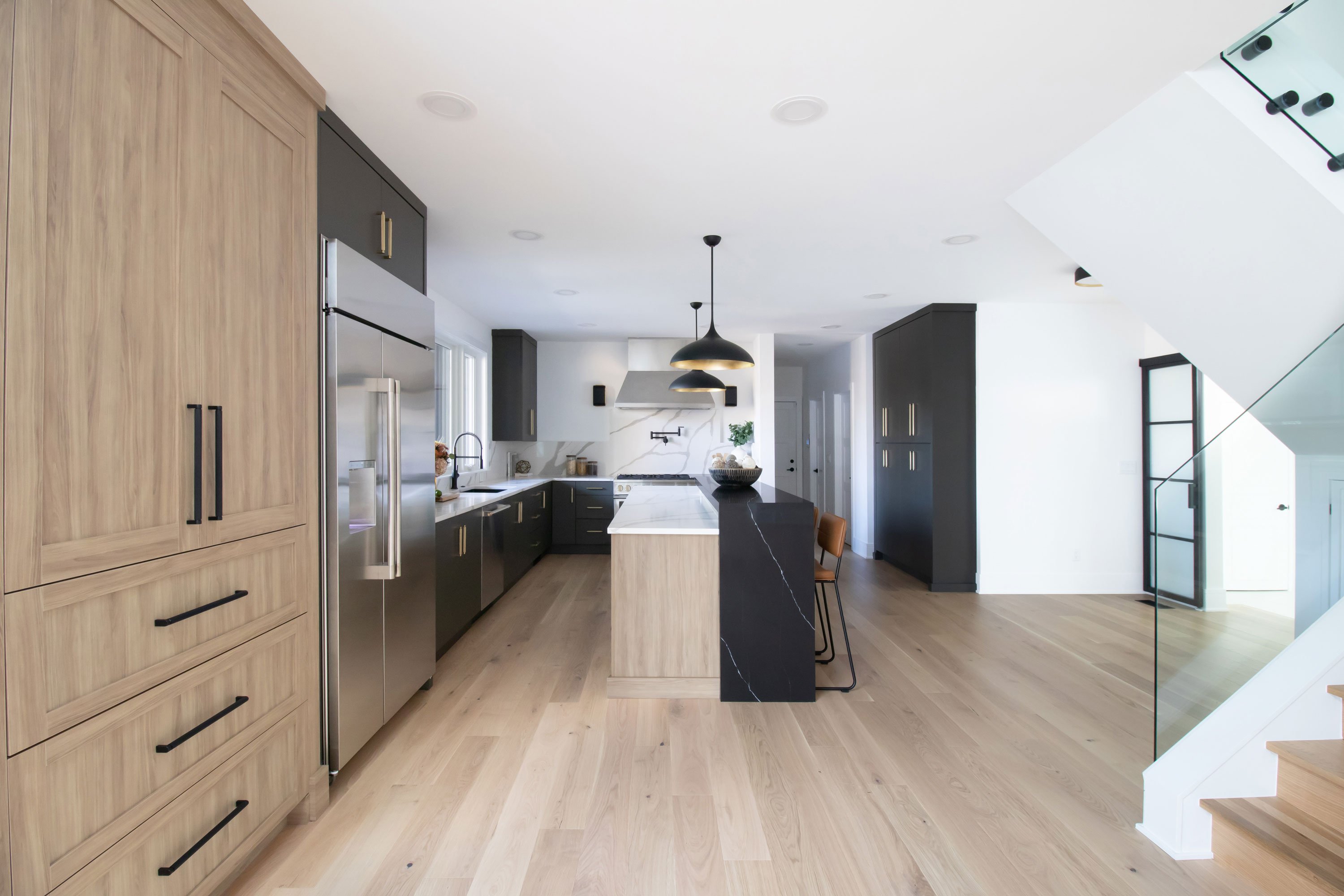 Contemporary kitchen featuring Inspira Cabinetry in the Milan door style with matte finish in Urbane Bronze and Chalet door style in textured melamine Peele finish