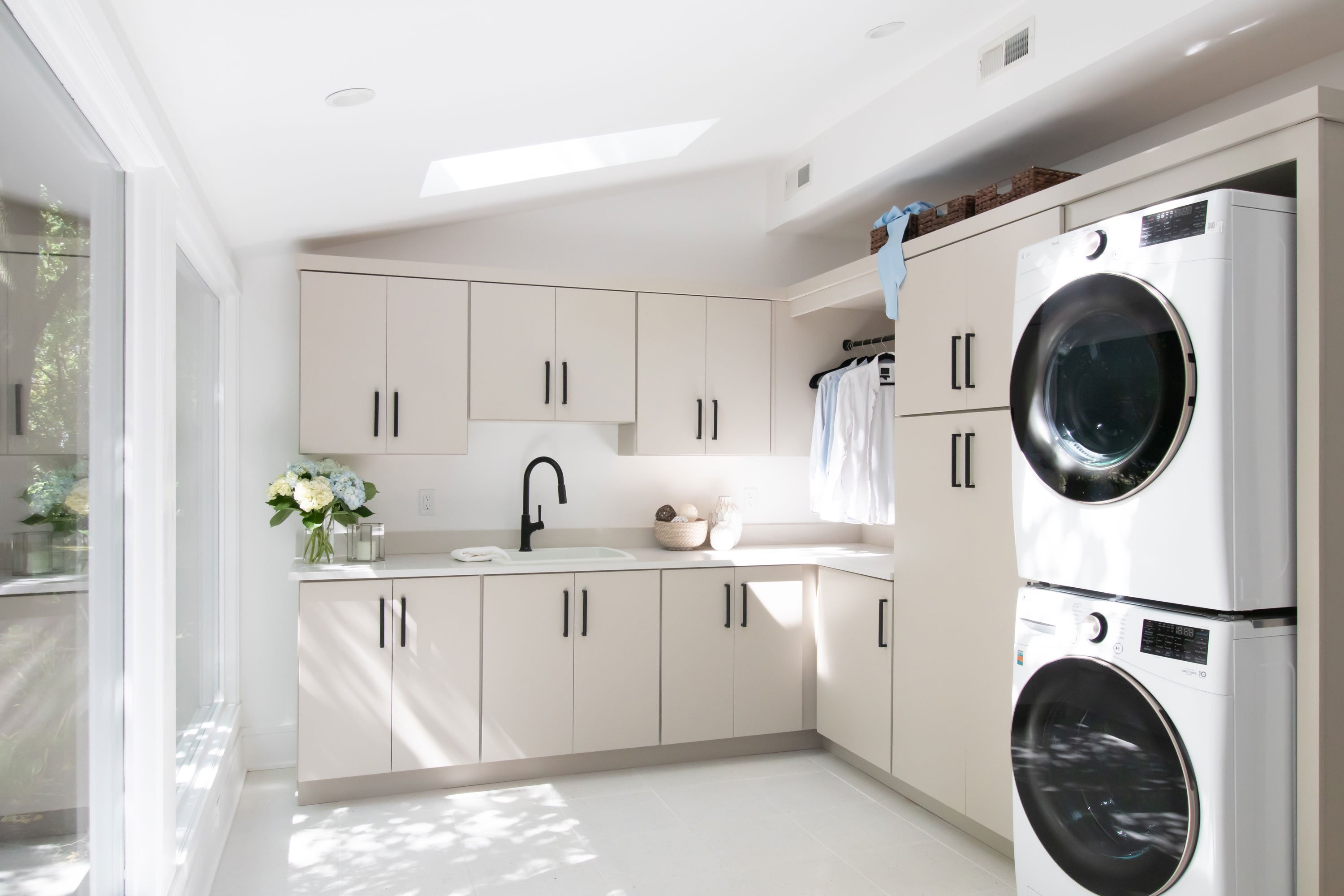 Laundry room featuring Medallion Cabinetry in the Bella door style with Irish Creme finish