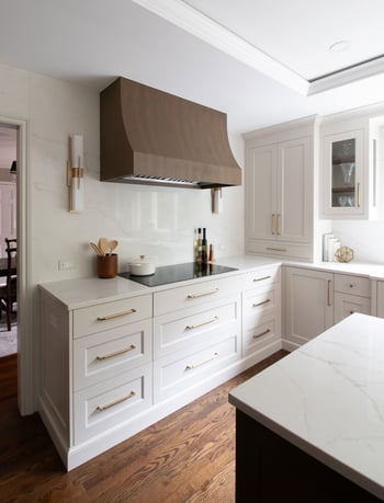 Wood hood ties into island and wood cabinetry on fridge wall