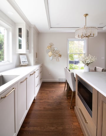 Stained oak floors match the rest of the home, with white and wood cabinetry providing contrast in the kitchen