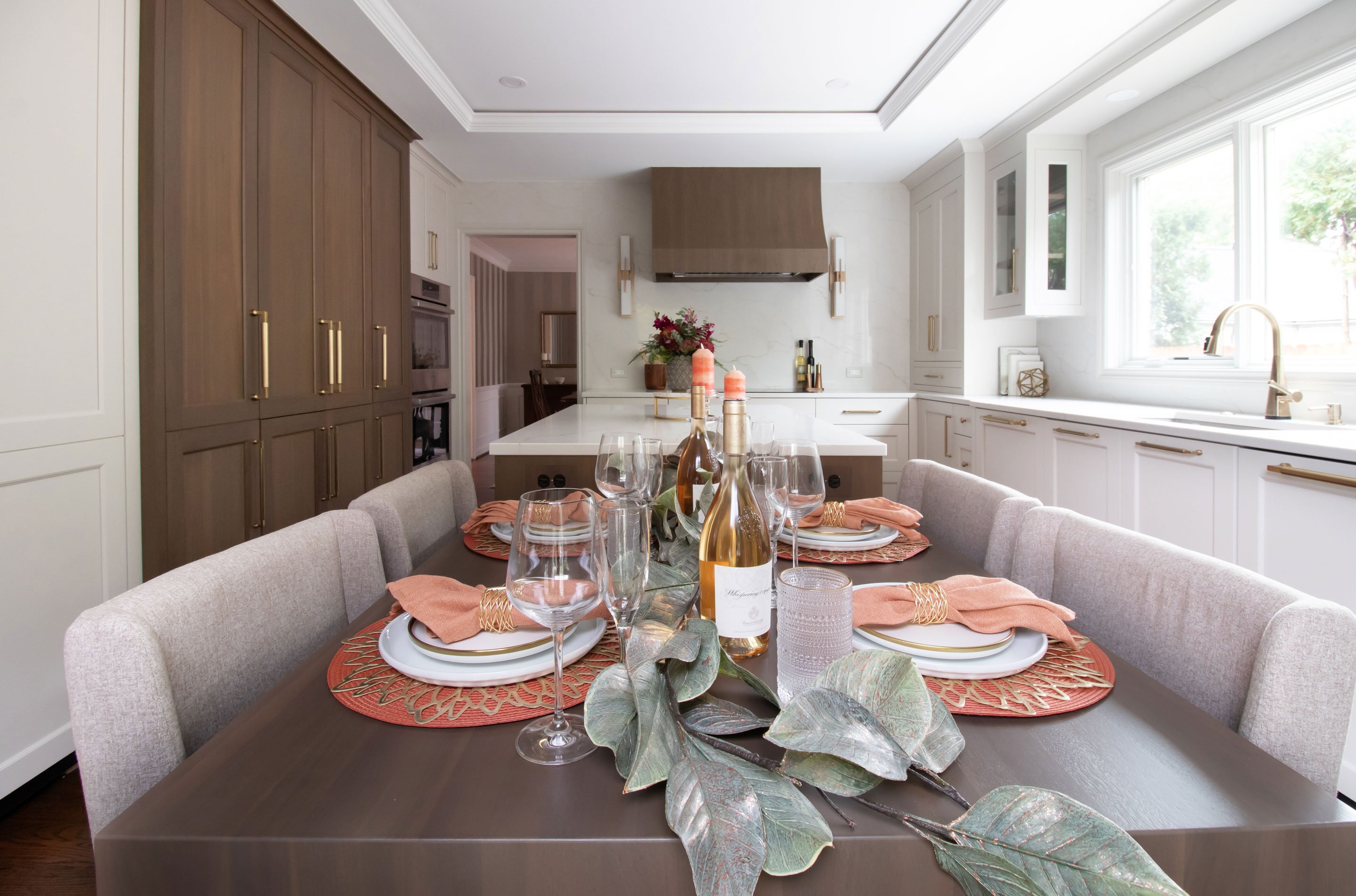 Wood waterfall island top provides an elegant setting for dining in the kitchen