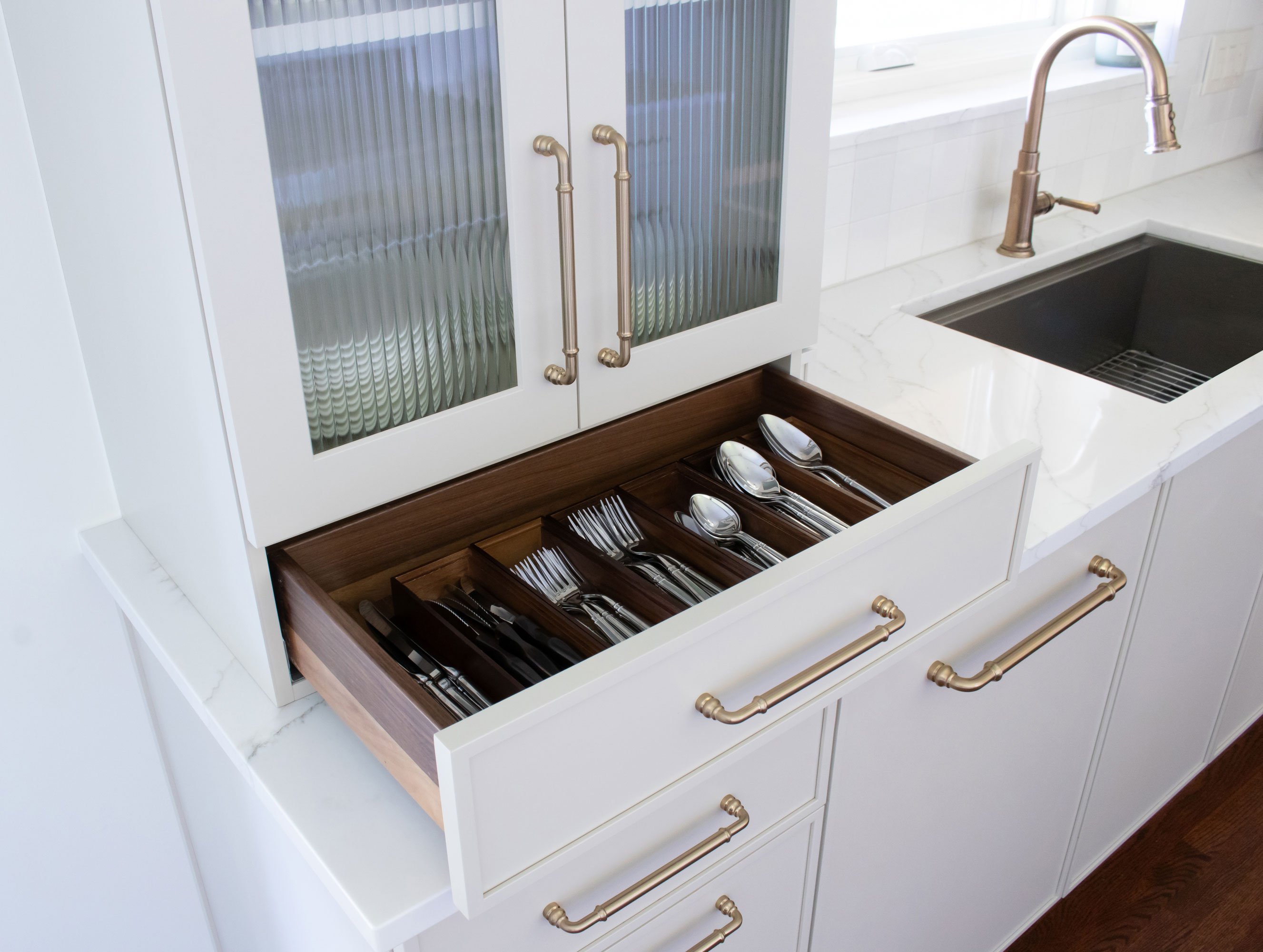 Inspira Cabinetry in the Aspen door style with Accessible Beige finish, featuring walnut drawer boxes