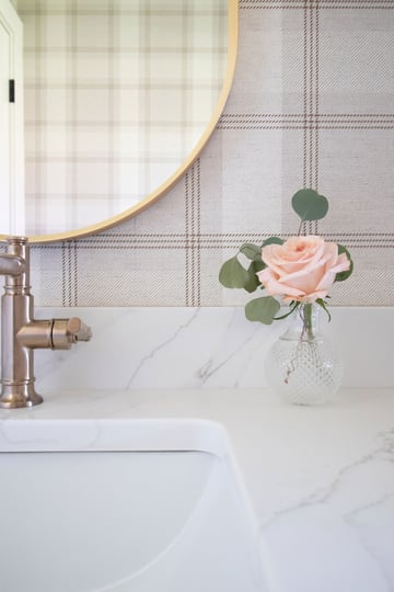 Soft fabric plaid wallpaper completes the powder room