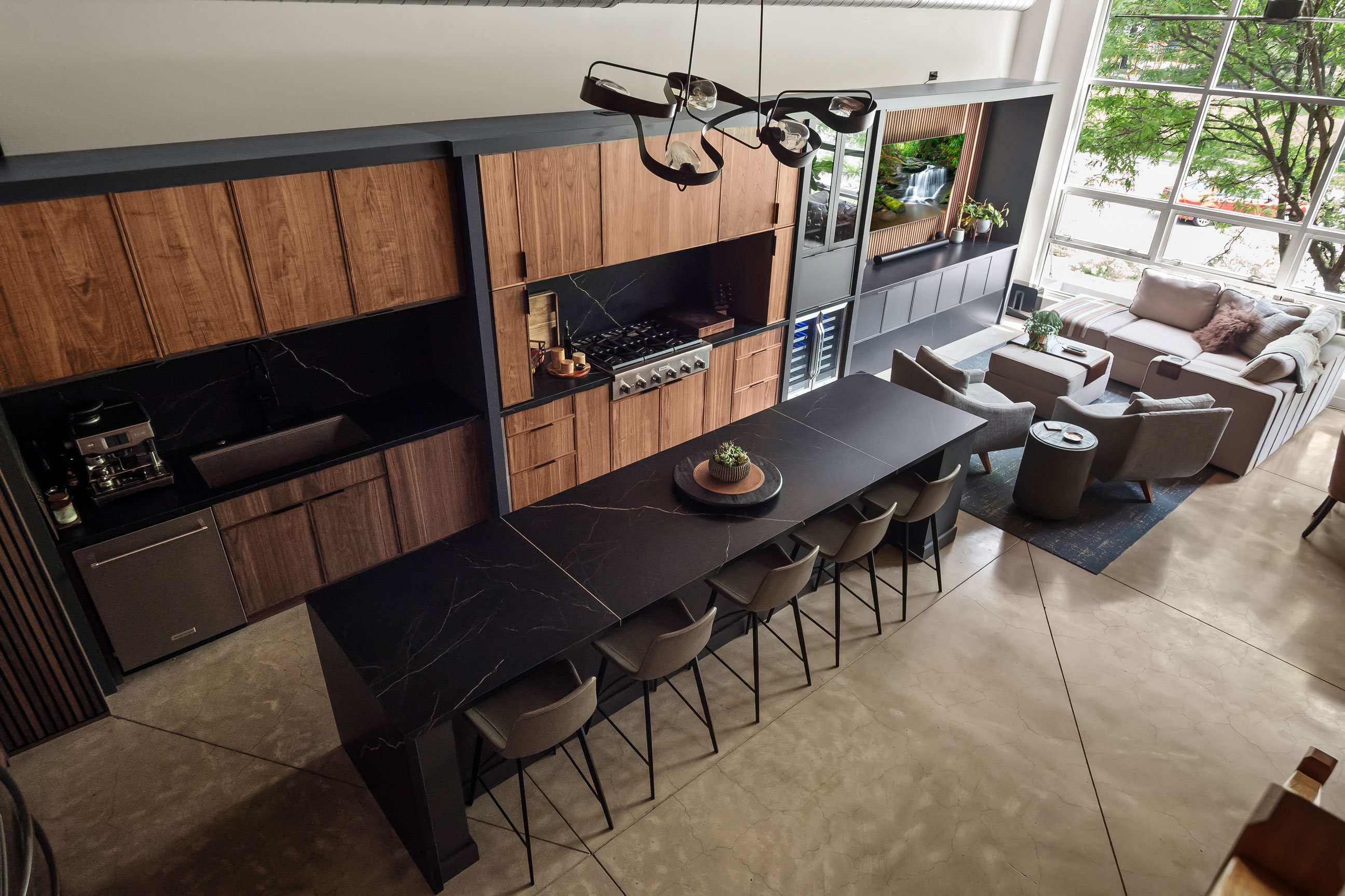 Contemporary loft kitchen featuring natural walnut and black-painted Inspira Cabinetry