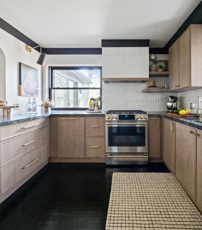 Moody meets Bright with black floors, countertops and trim contrasting bright tile and warm wood cabinetry