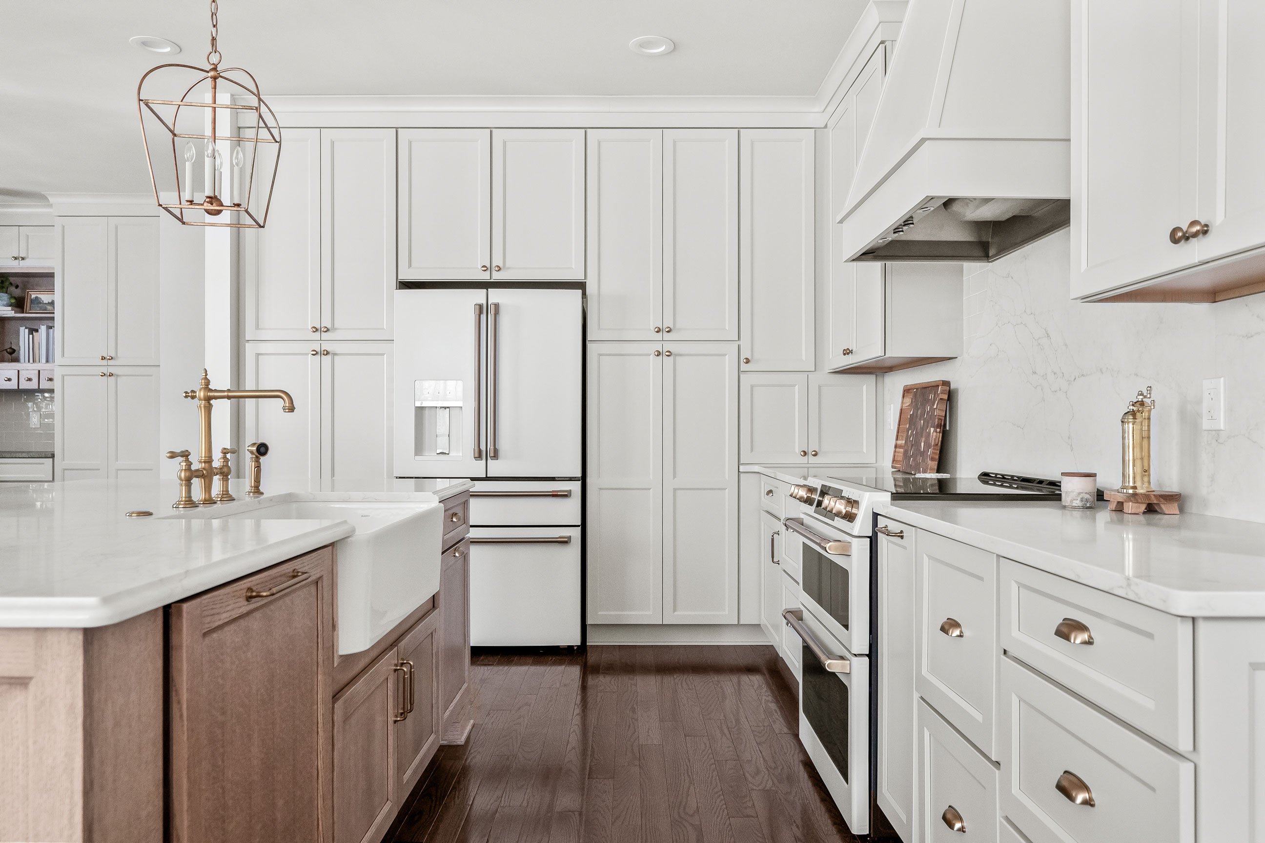 Remodeled kitchen featuring full-height cabinetry, oak island, and pendant lighting.