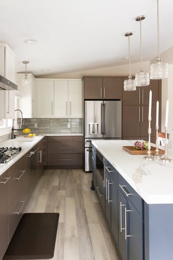 Eco-friendly rift-cut oak veneer cabinetry with a warm stain on the perimeter.  Island features euro-style slim shaker doors in a rich blue.