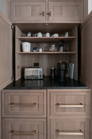 Inspira Cabinetry inset cabinetry creates a stunning coffee bar with pocket doors