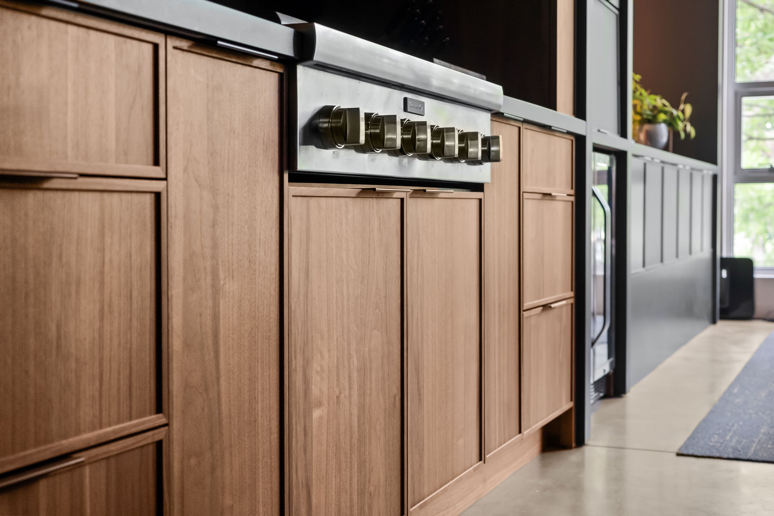 Close up of a kitchen island featuring walnut cabinetry