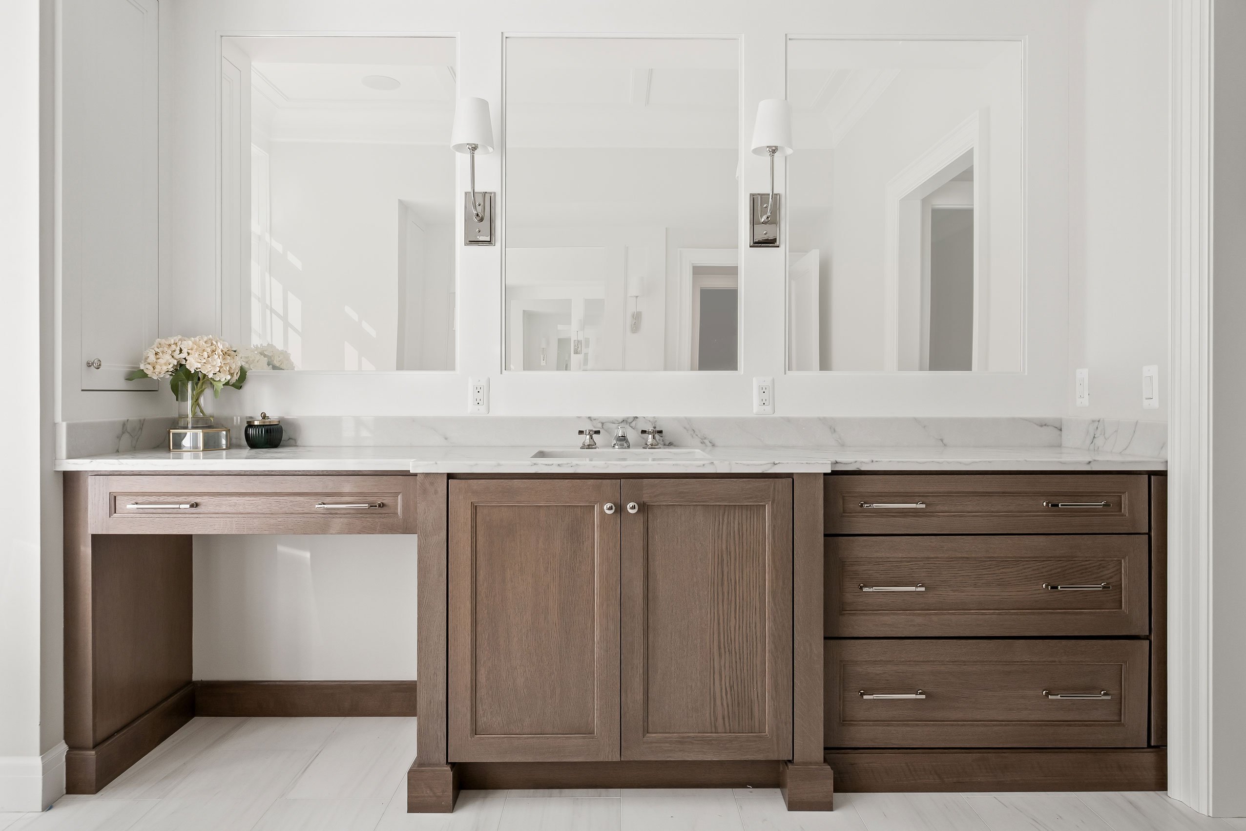 Large vanity in master bath featuring makeup station and warm white oak cabinetry.