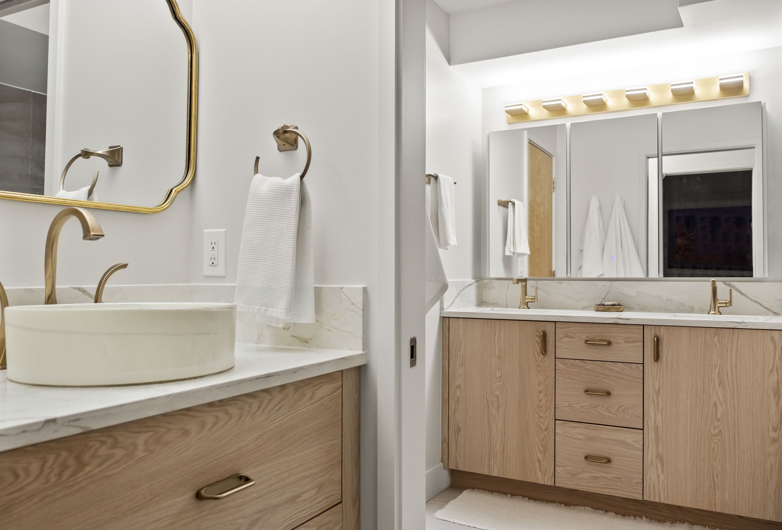 Spa-like bath with gold-toned fixtures and statement lighting