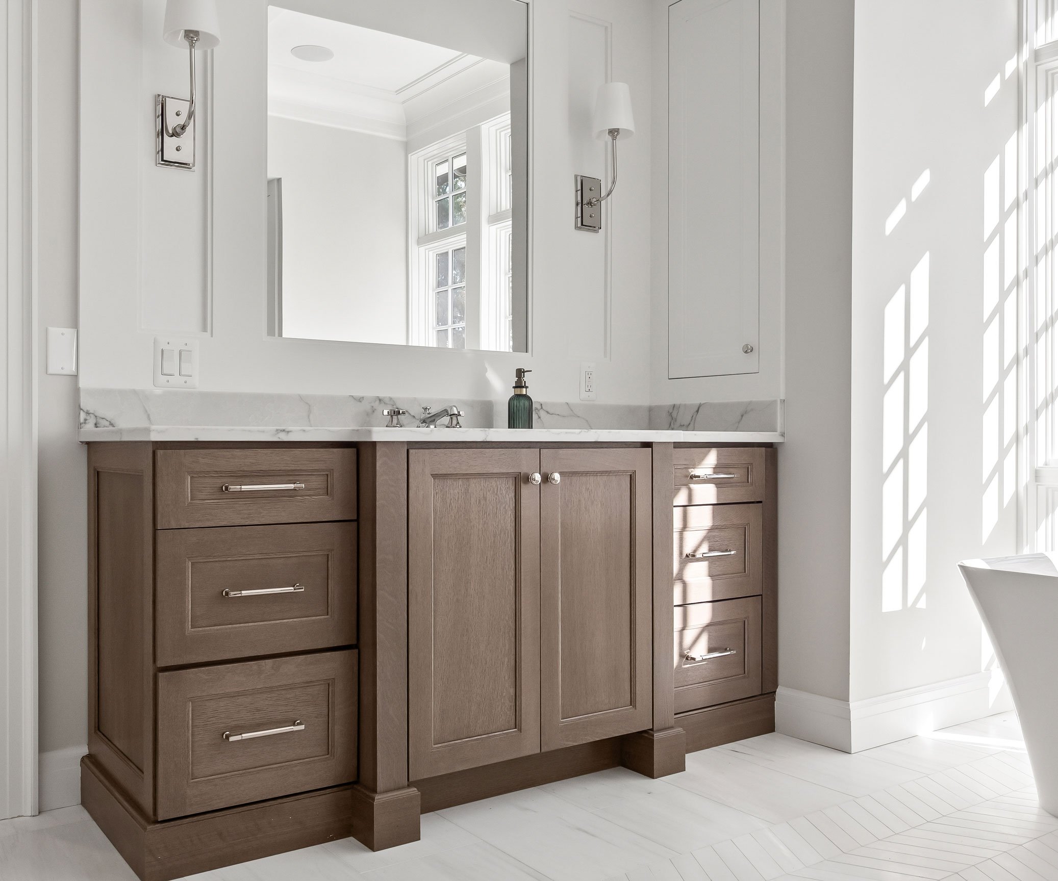 Second vanity in primary bath featuring warm white oak cabinetry.