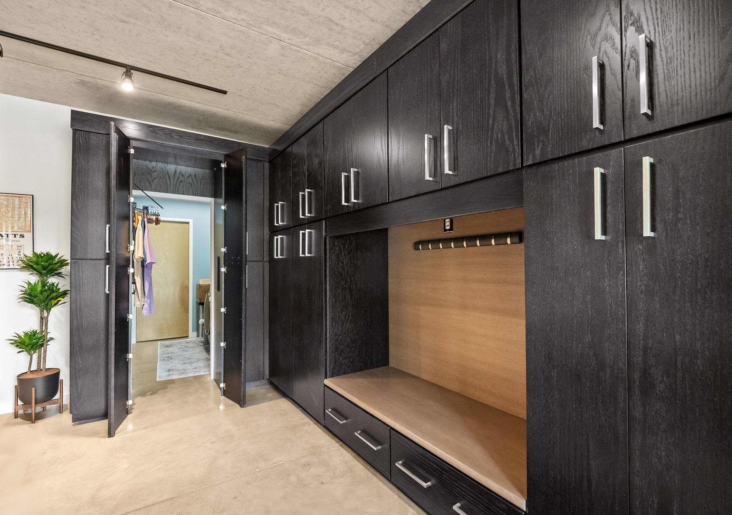 Contemporary mudroom with hidden access to laundry room
