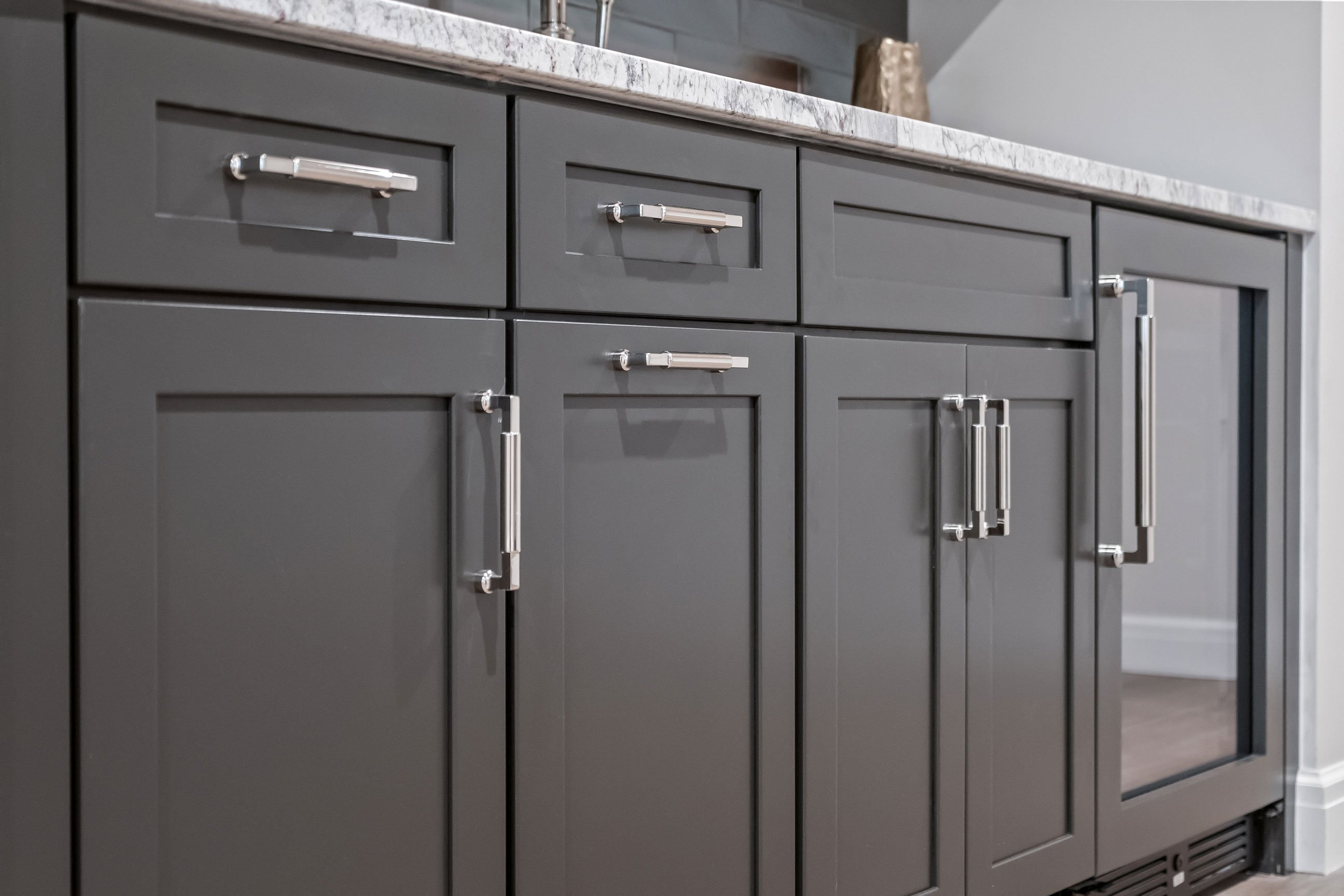 Lower-level bar area moody dark cabinetry detail.