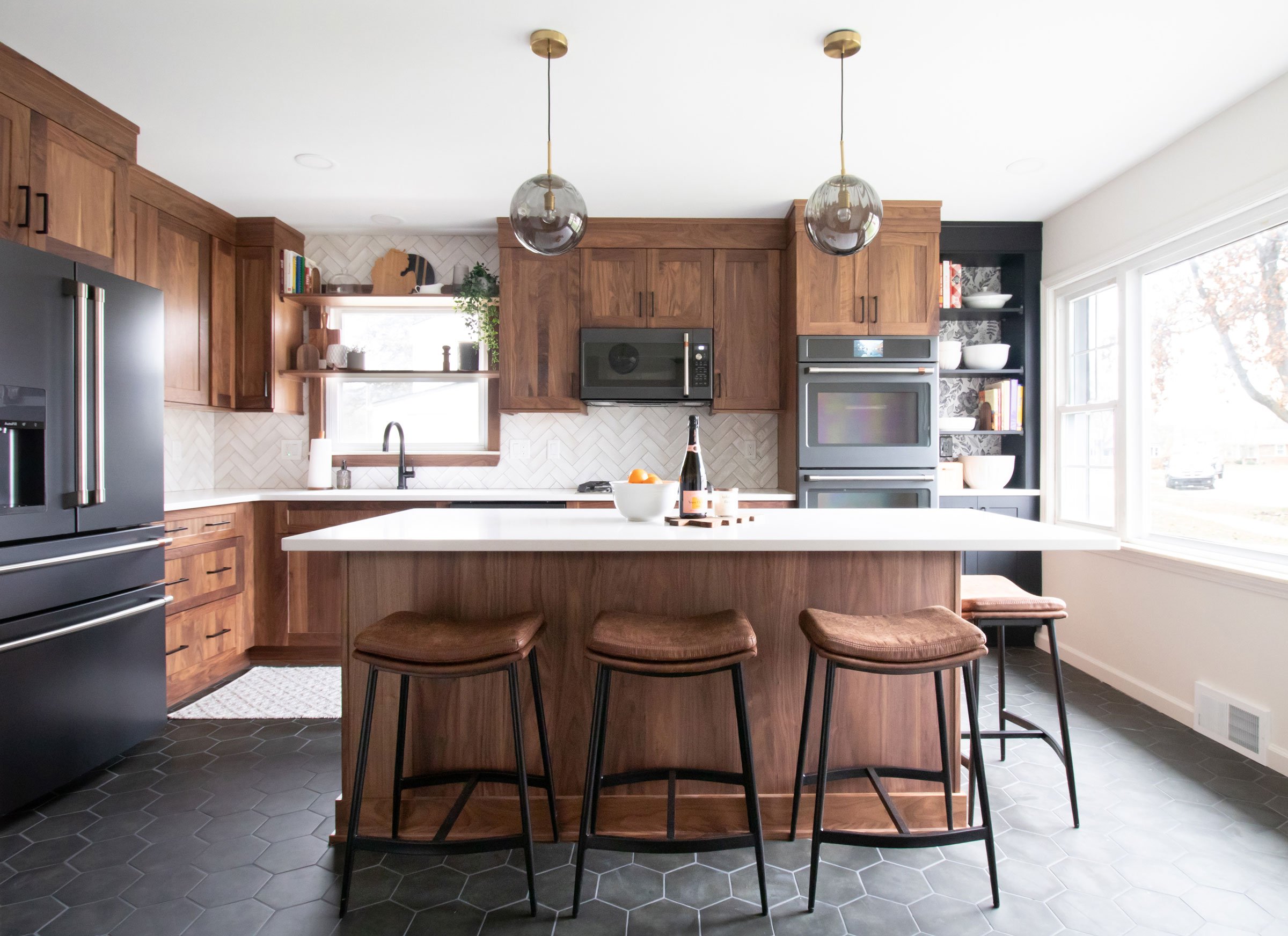 Kitchen featuring biophilic elements such as walnut cabinetry and floral print wallpaper. Designed by KSI Sr. Designer Krista Daily.