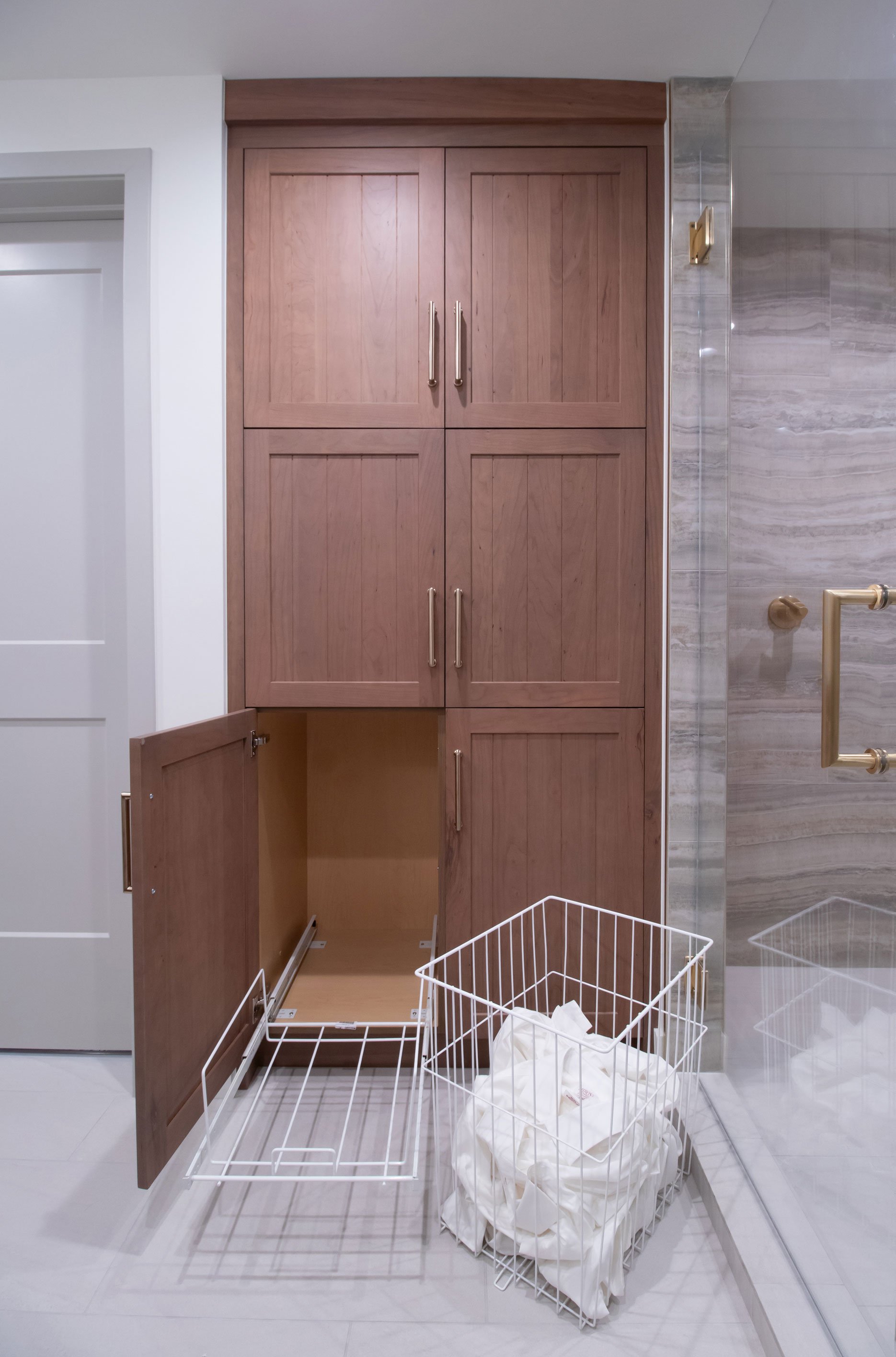 Linen cabinet with retractable laundry basket