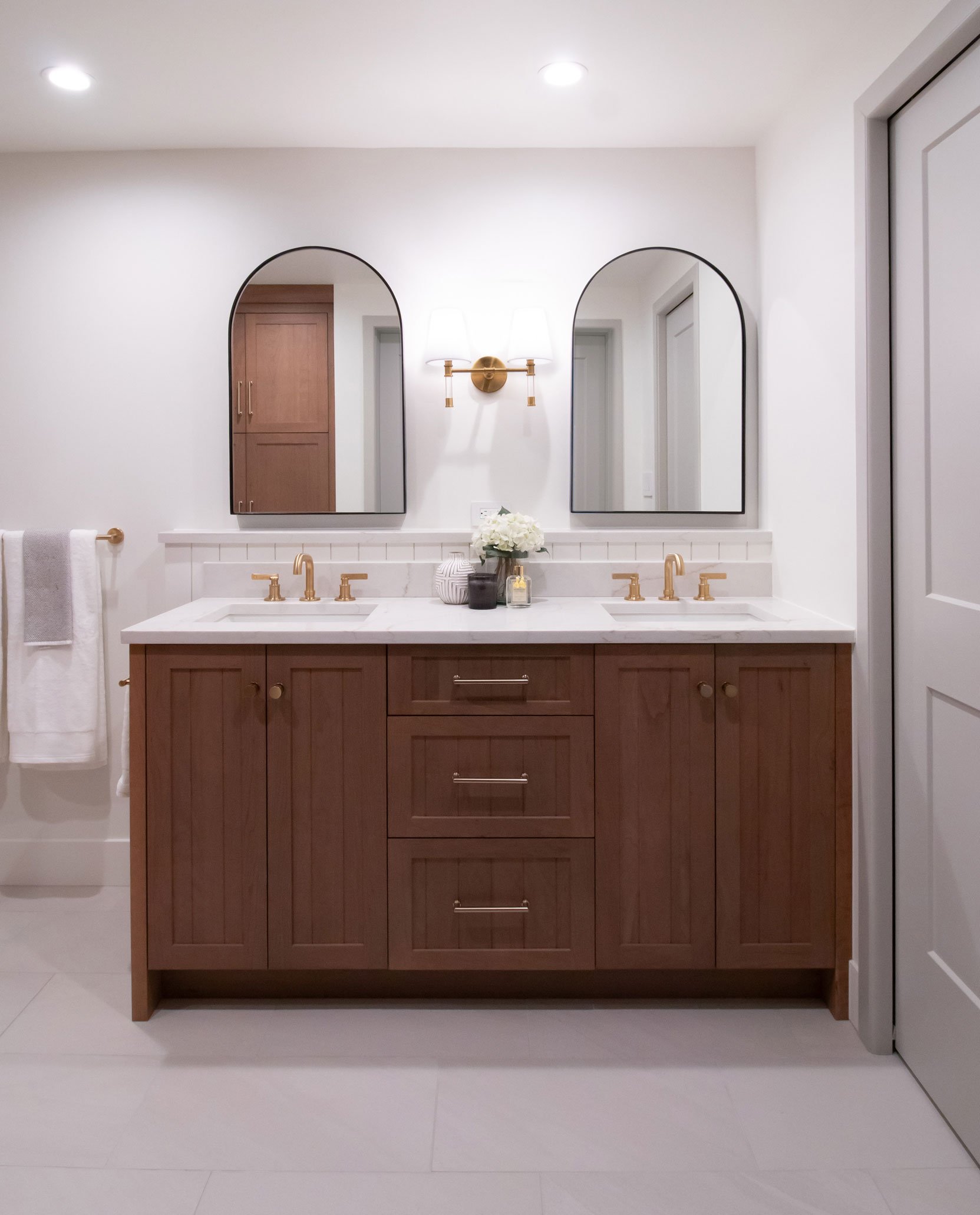 Dual vanity with warm wood cabinetry