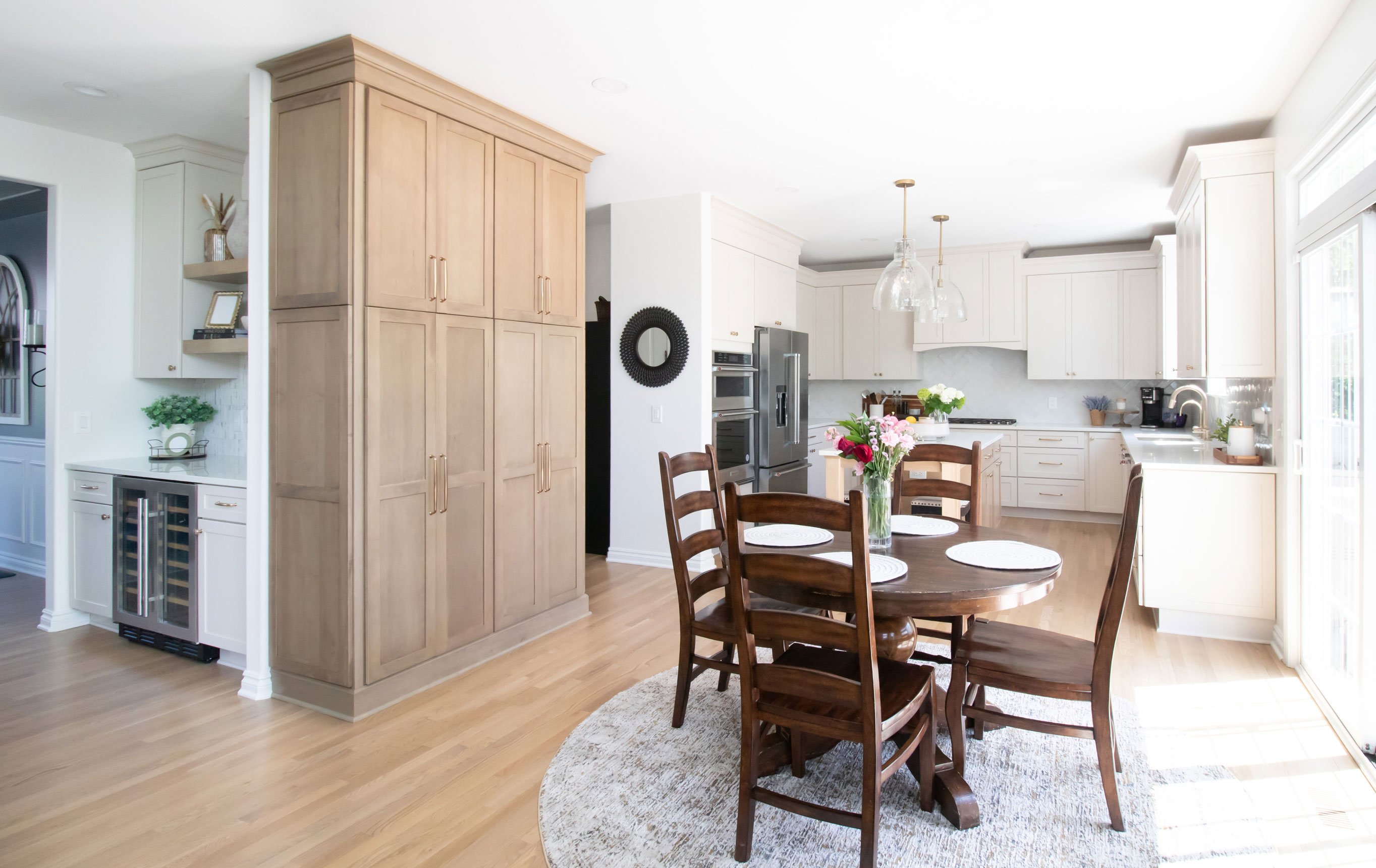 Cabinetry: Merillat Masterpiece Martel Door in Cottage Paint and Maple with Wicker Stain; Countertops: French Lace Quartz; Tile: Marazzi Rice Bianco 3x8 in herringbone pattern (kitchen), Artistic Tile Abbey Road Calacatta Gold Marble Mosaic, honed (butler's pantry)