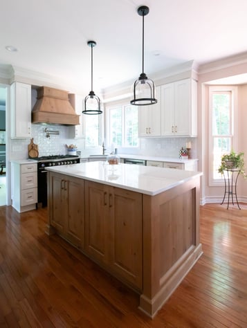 Transitional French Country style kitchen with blend of white and hickory cabinets and white countertops