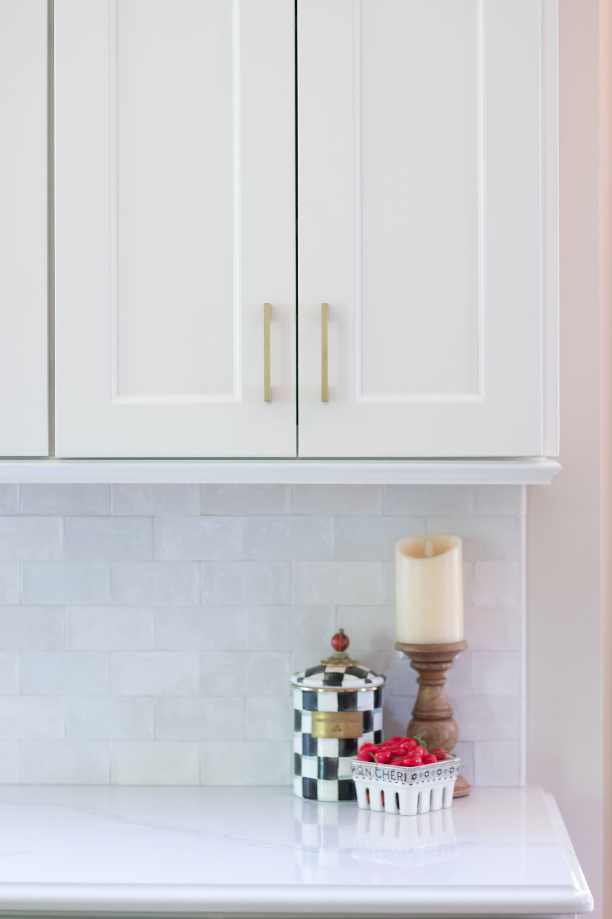 Transitional French Country style kitchen with white cabinets and white countertops