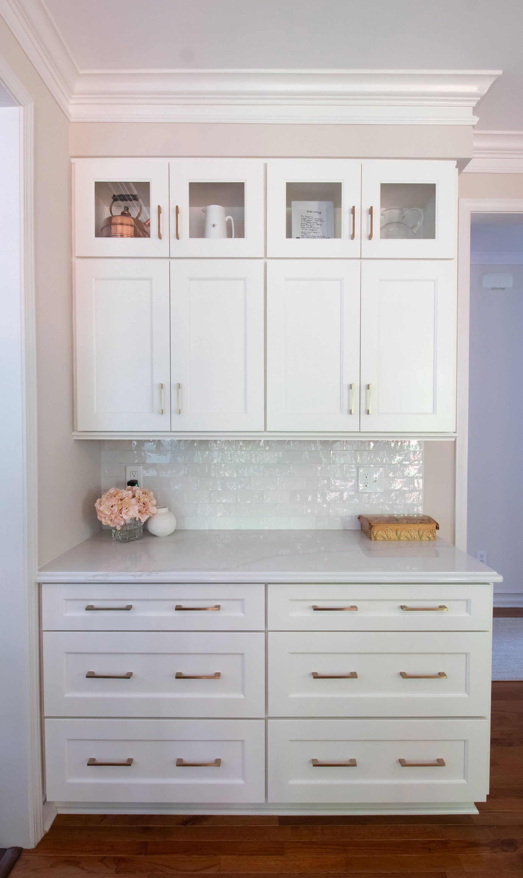 Transitional French Country style kitchen with blend of white cabinets and white countertops