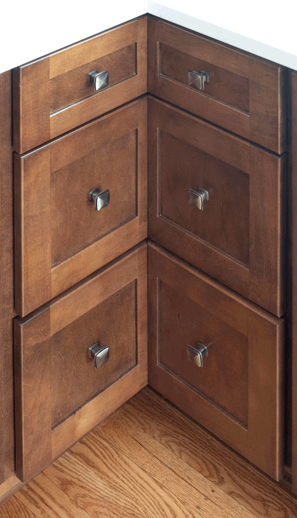 Corner drawers from Merillat Masterpiece cabinetry in the Martel door style, featuring maple wood in Cognac finish.