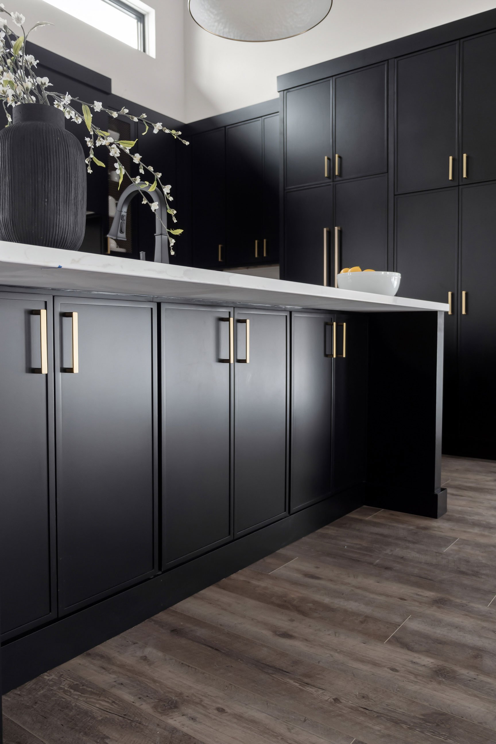 Closeup detail of slim shaker cabinetry in black paint finish