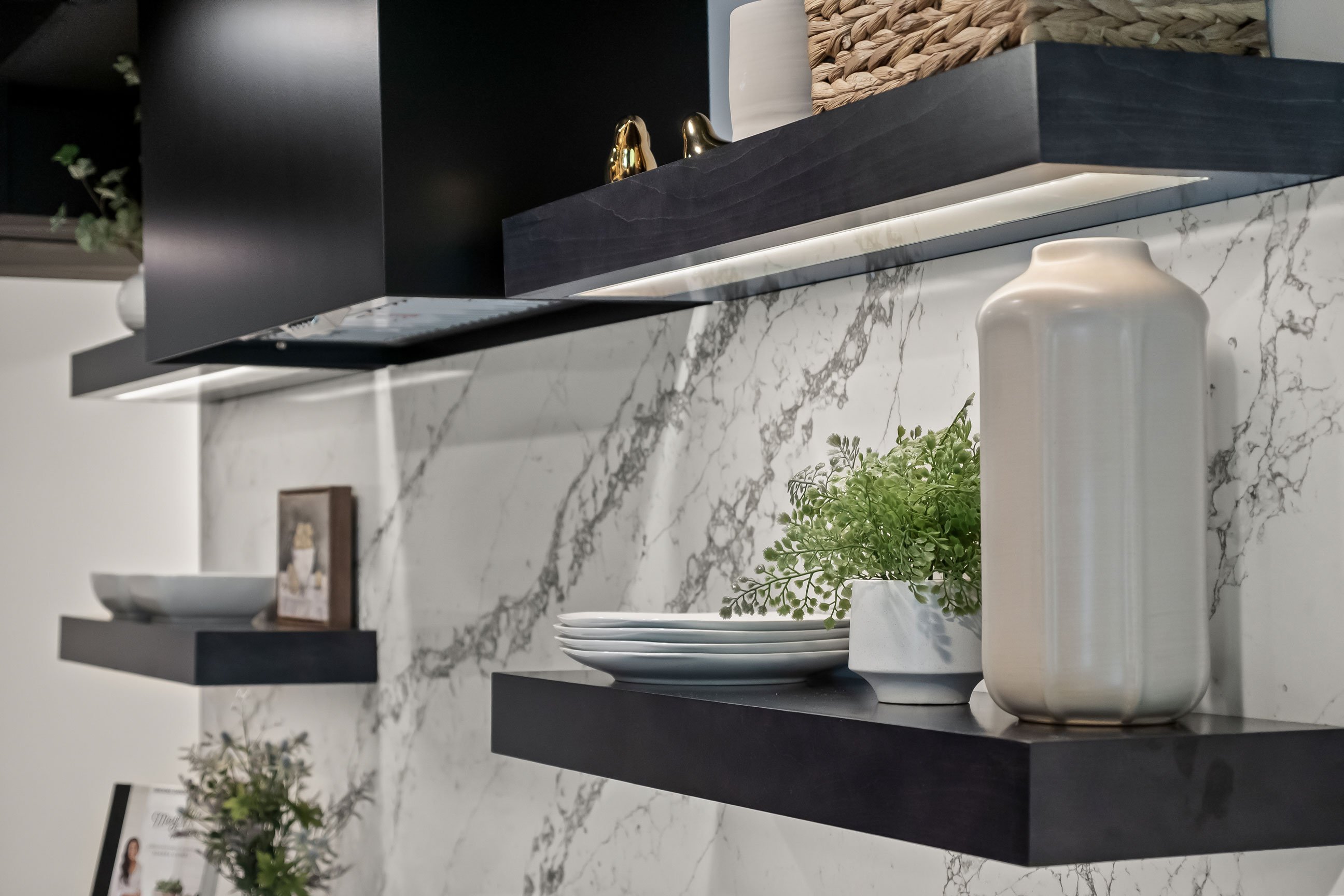 Floating shelves with quartz backsplash keep the kitchen light and airy.
