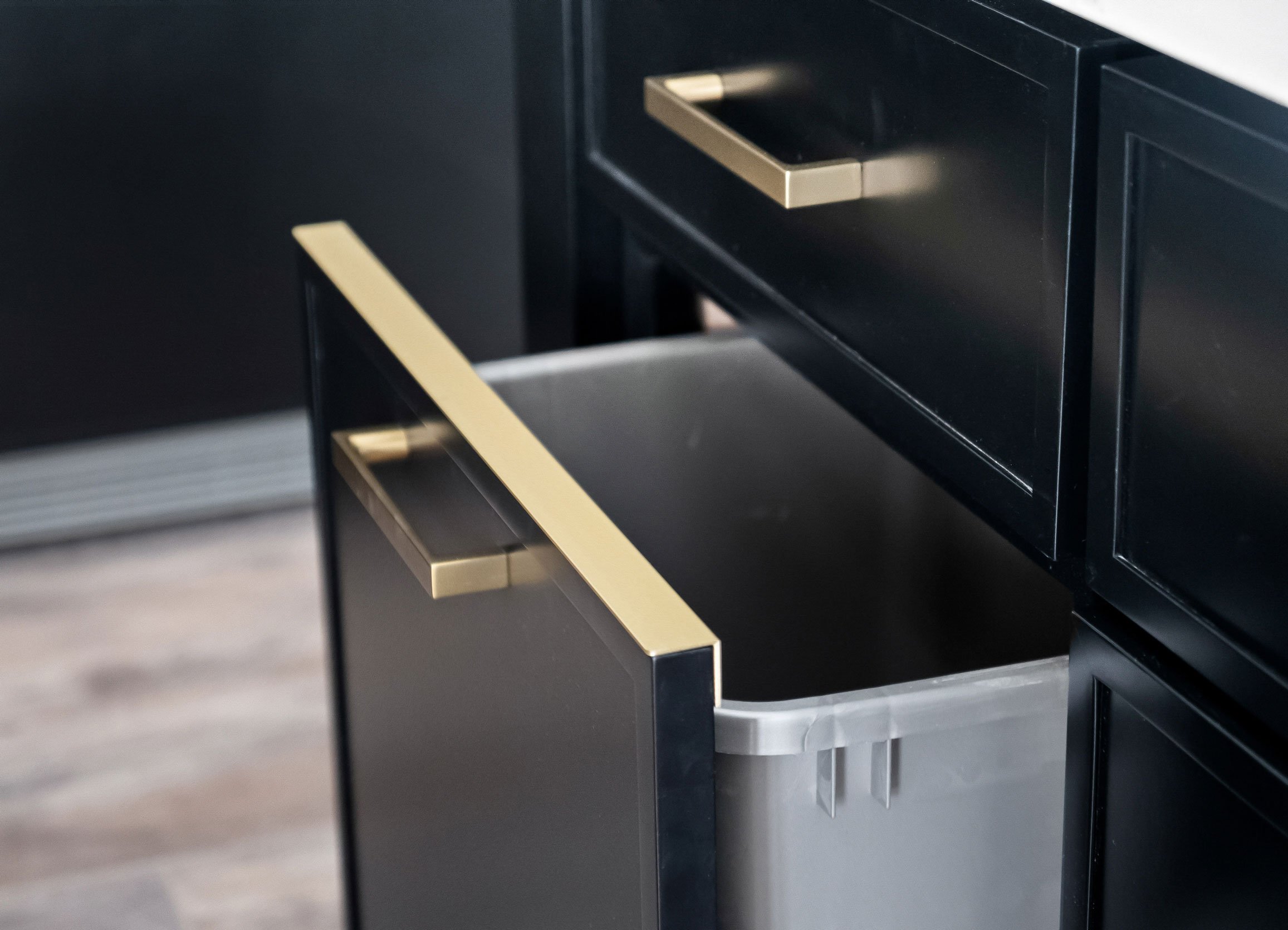 Drip edge hardware detail for trash pull-out cabinet