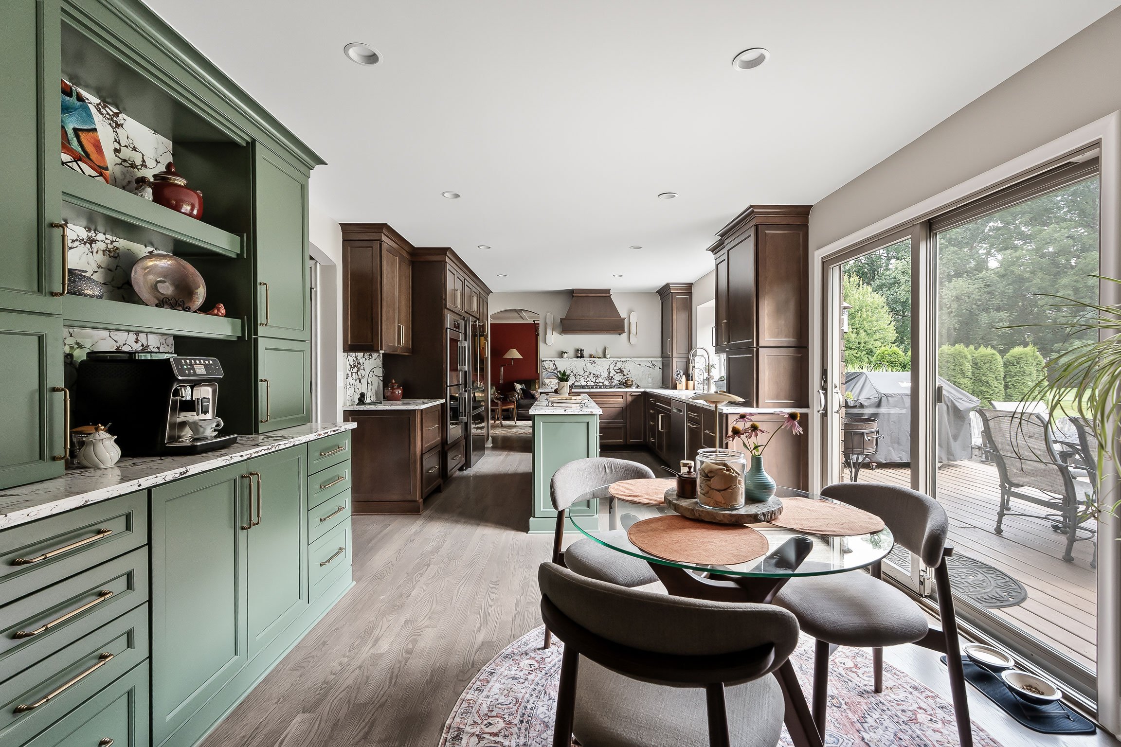 Wide view of the Evergreen coffee station hutch with the kitchen and breakfast nook visible beyond, opening to the deck.