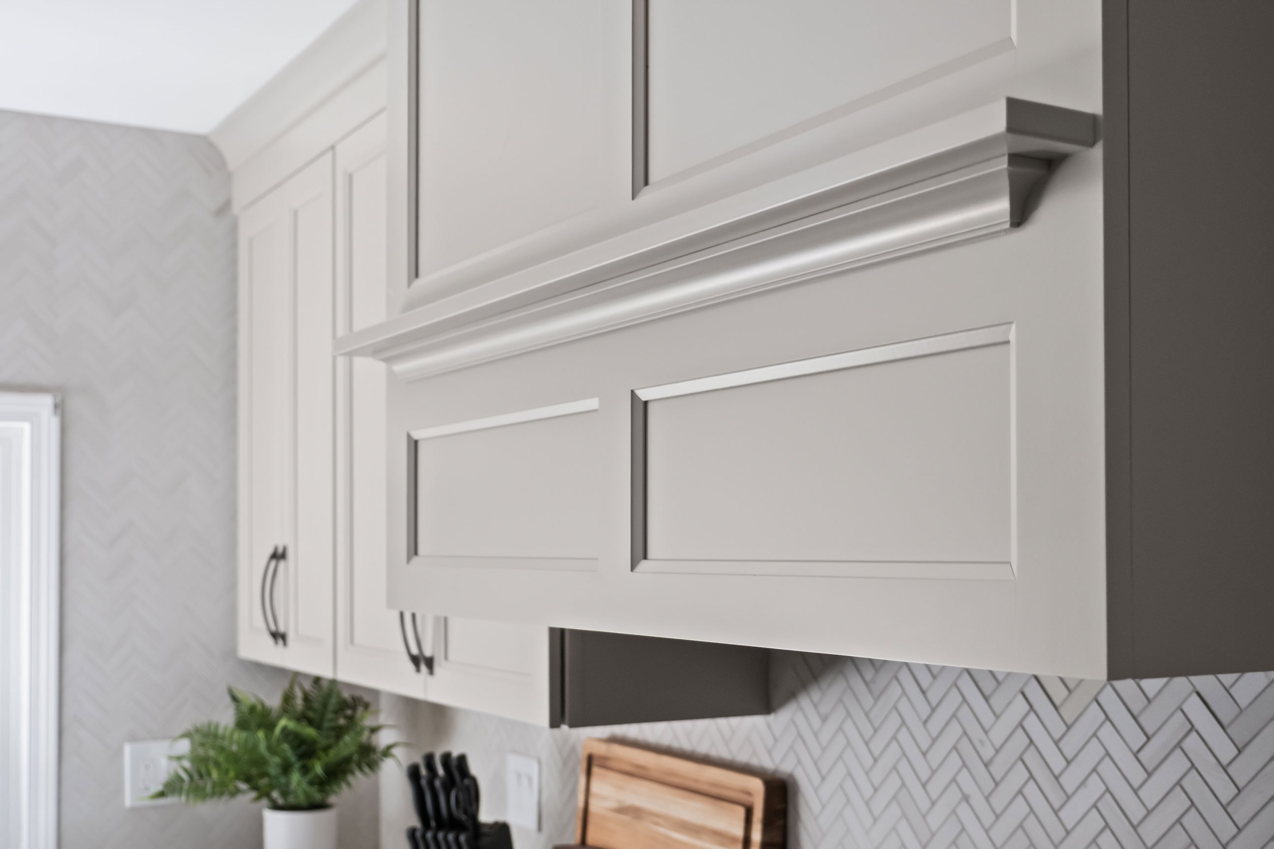 A detail shot of the range hood's crown molding and cabinetry trim.