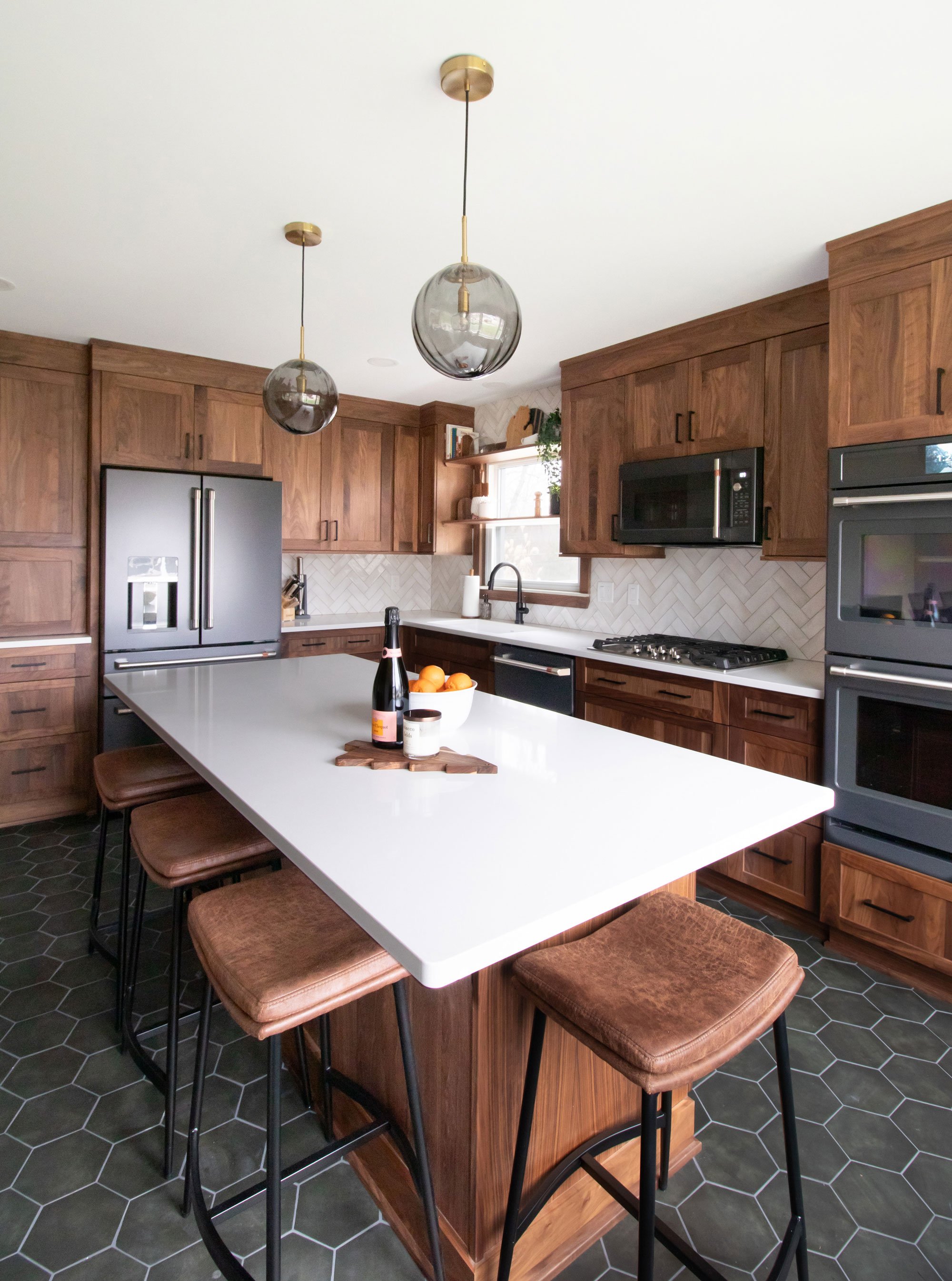 Inspira Cabinetry in natural walnut with matte black hardware and appliances