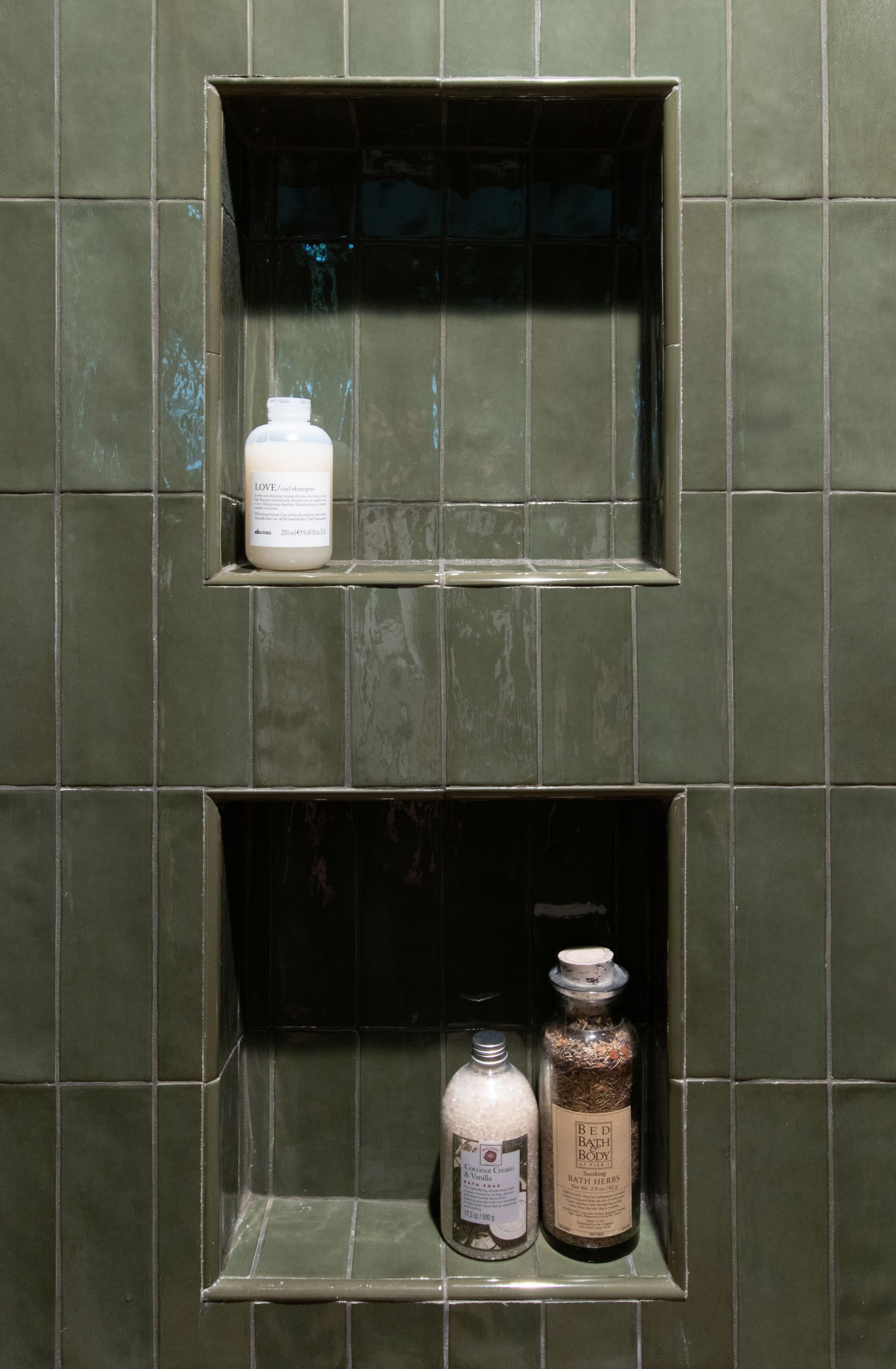 Shower niche detail with built-in storage and green tile