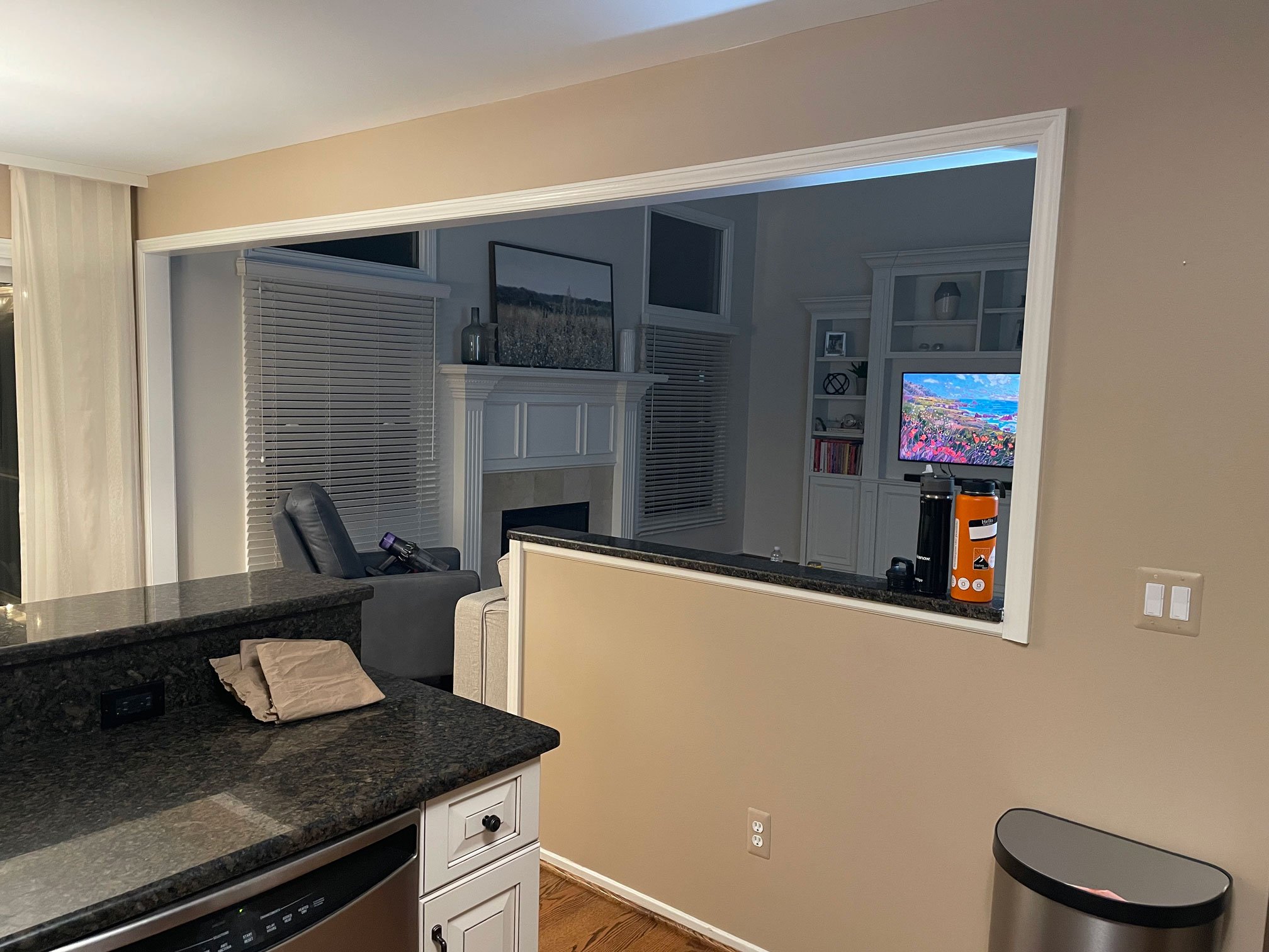 Raised peninsula and half wall separating the kitchen from the adjacent living room.