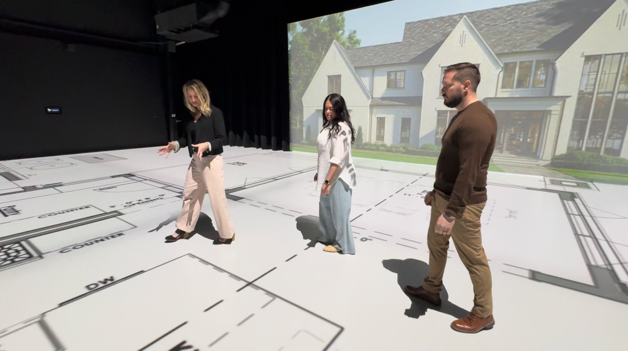 Sandra Daubenmeyer discusses kitchen layout and appliance placement during a full-scale immersive plan review at TrueScale Studio.