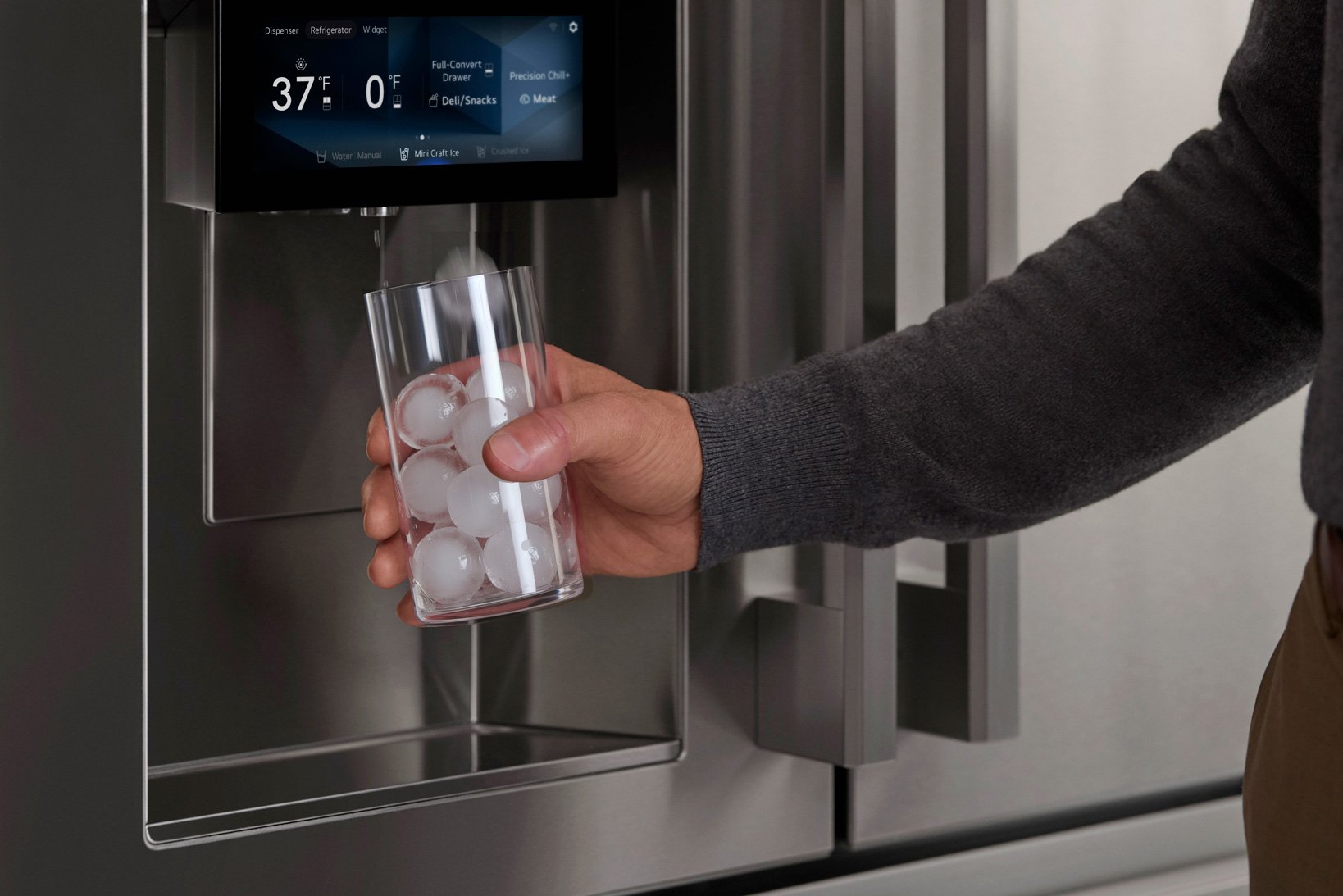modern appliances, refrigerator featuring water glass being fillled